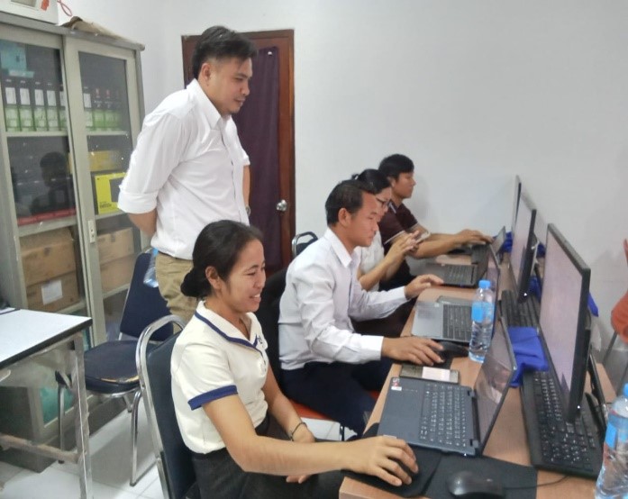 A man overseeing computer users in a computer laboratory