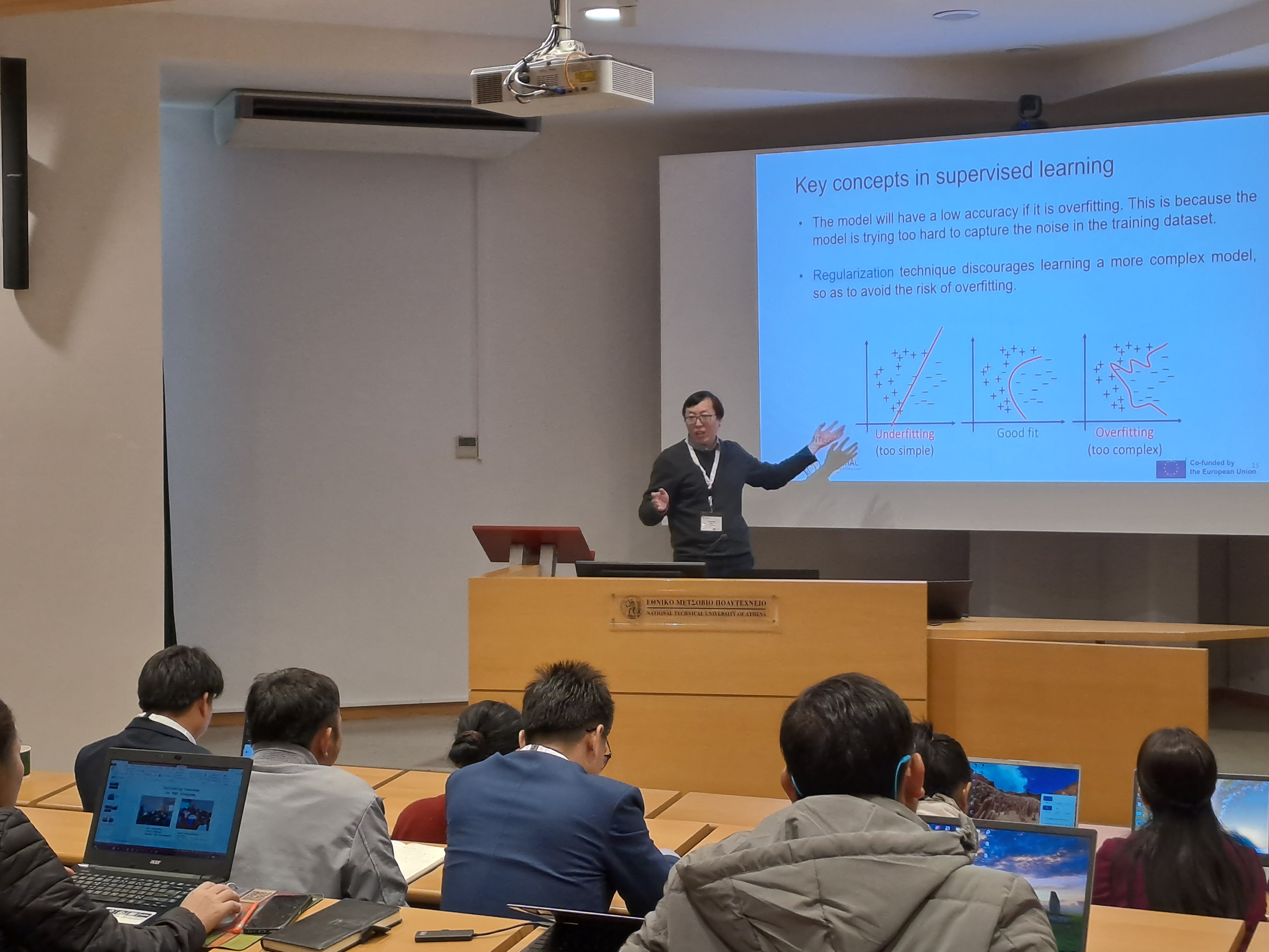 Lecturer presenting a slide on supervised learning
