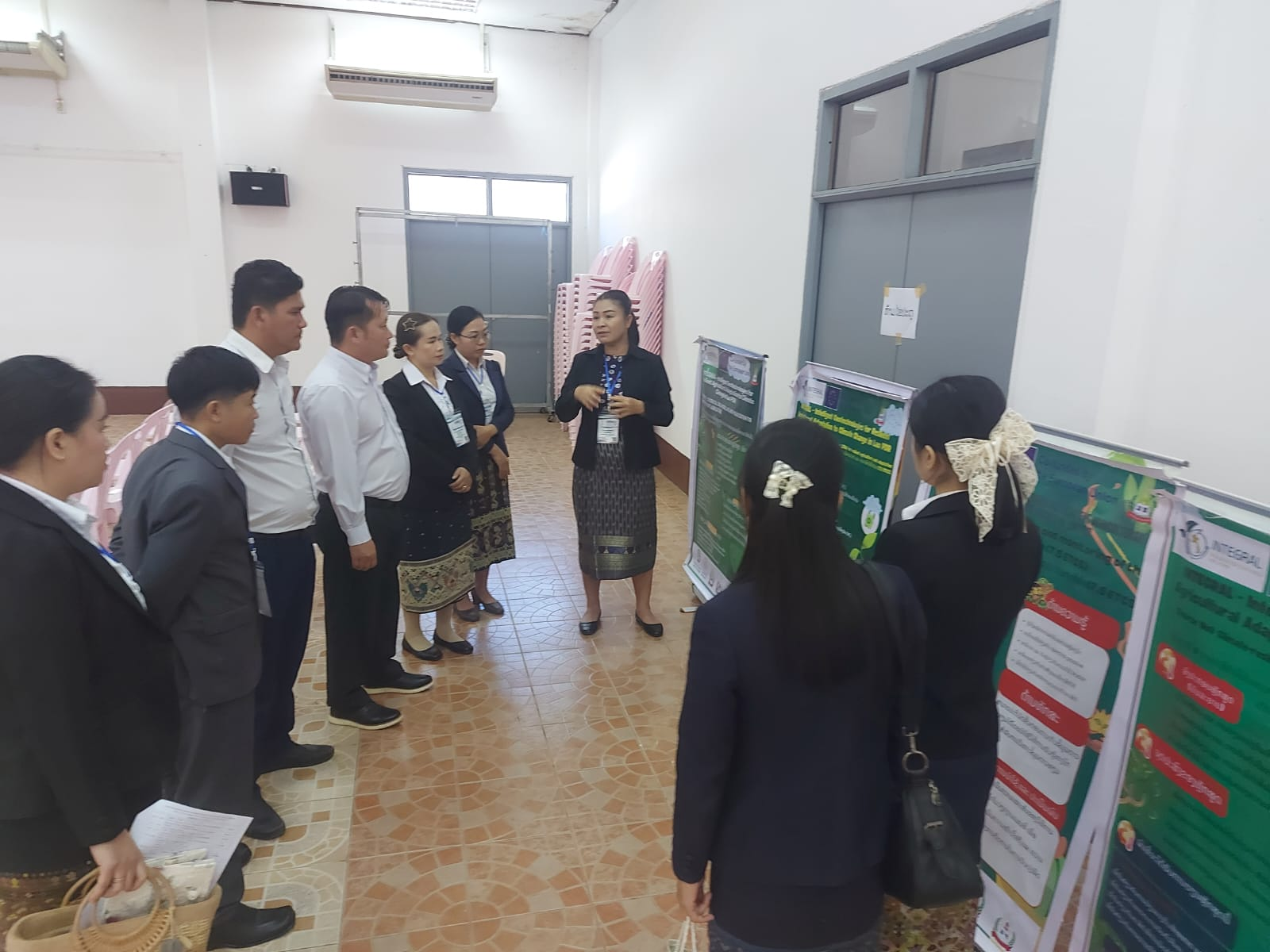 A woman explaining a poster to a group of people