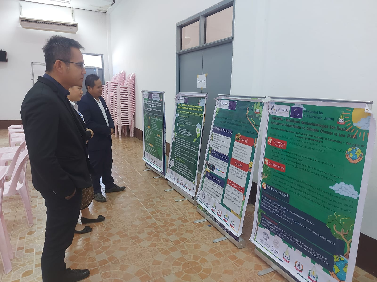 A group of people looking at a series of posters